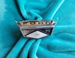 1959 Ford Hood Emblem Bezel And Insert 1007537 B9-16607 B9A-16644. Fixed Price $50.00.