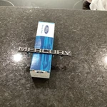 Nos 1985 Mercury Cougar Front Name Plate E5WY-8A223-A. Fixed Price $40.00.